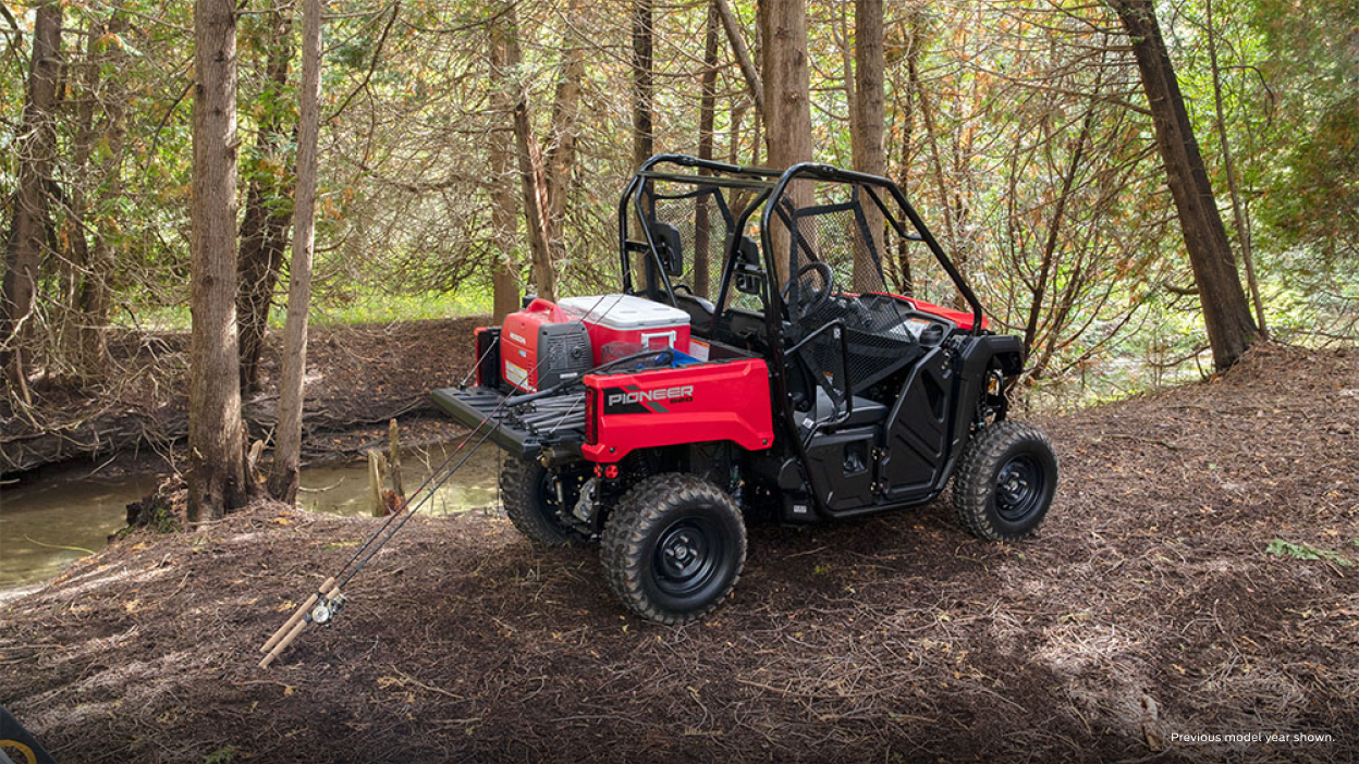 Riders in a Honda Pioneer 520 in the forest 